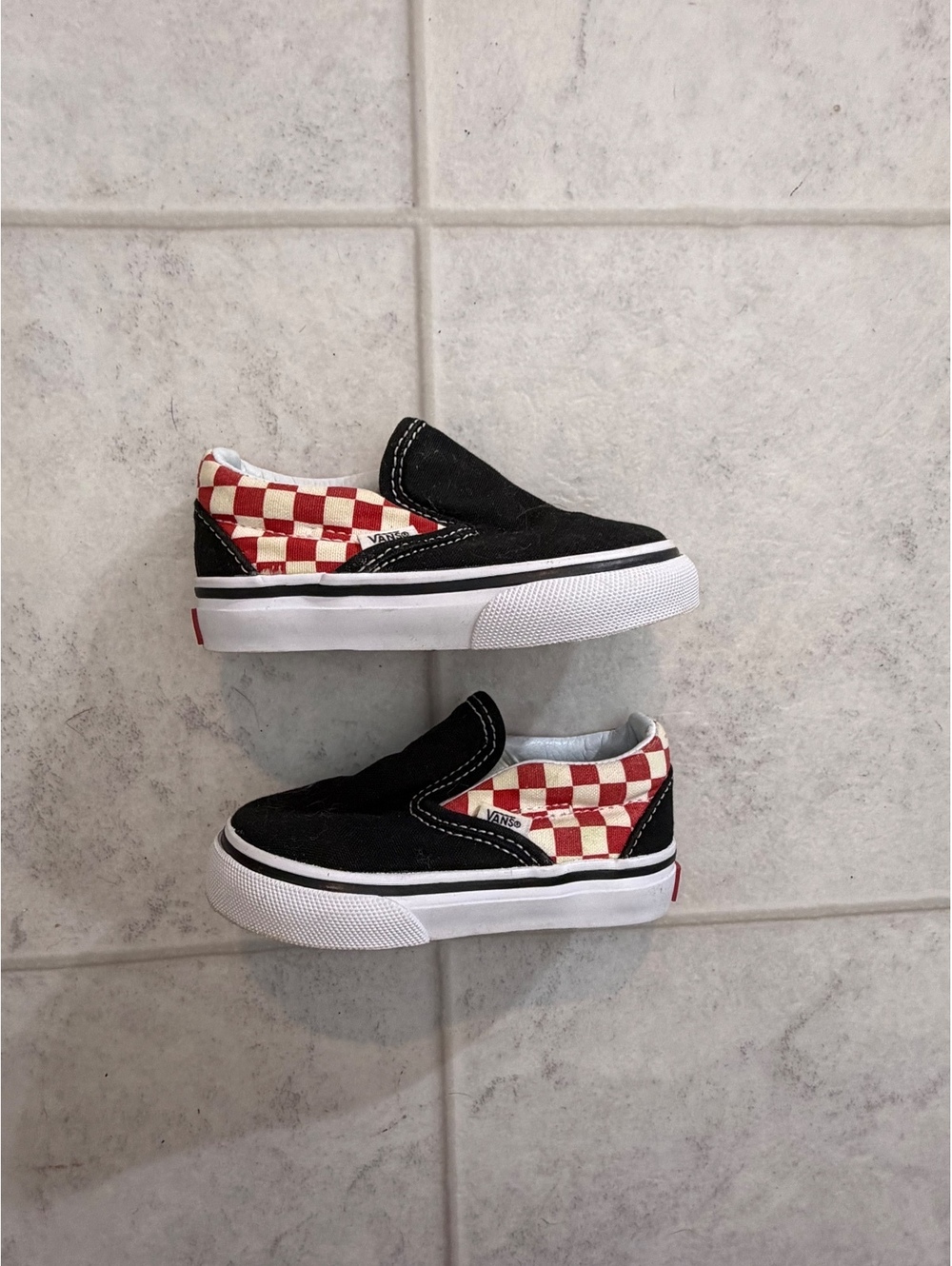 Vans black and red checkerboard slip-on sneakers